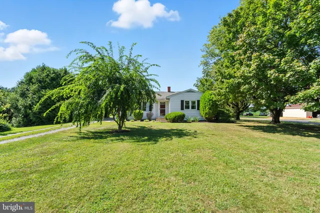 a front view of a house with a yard and porch