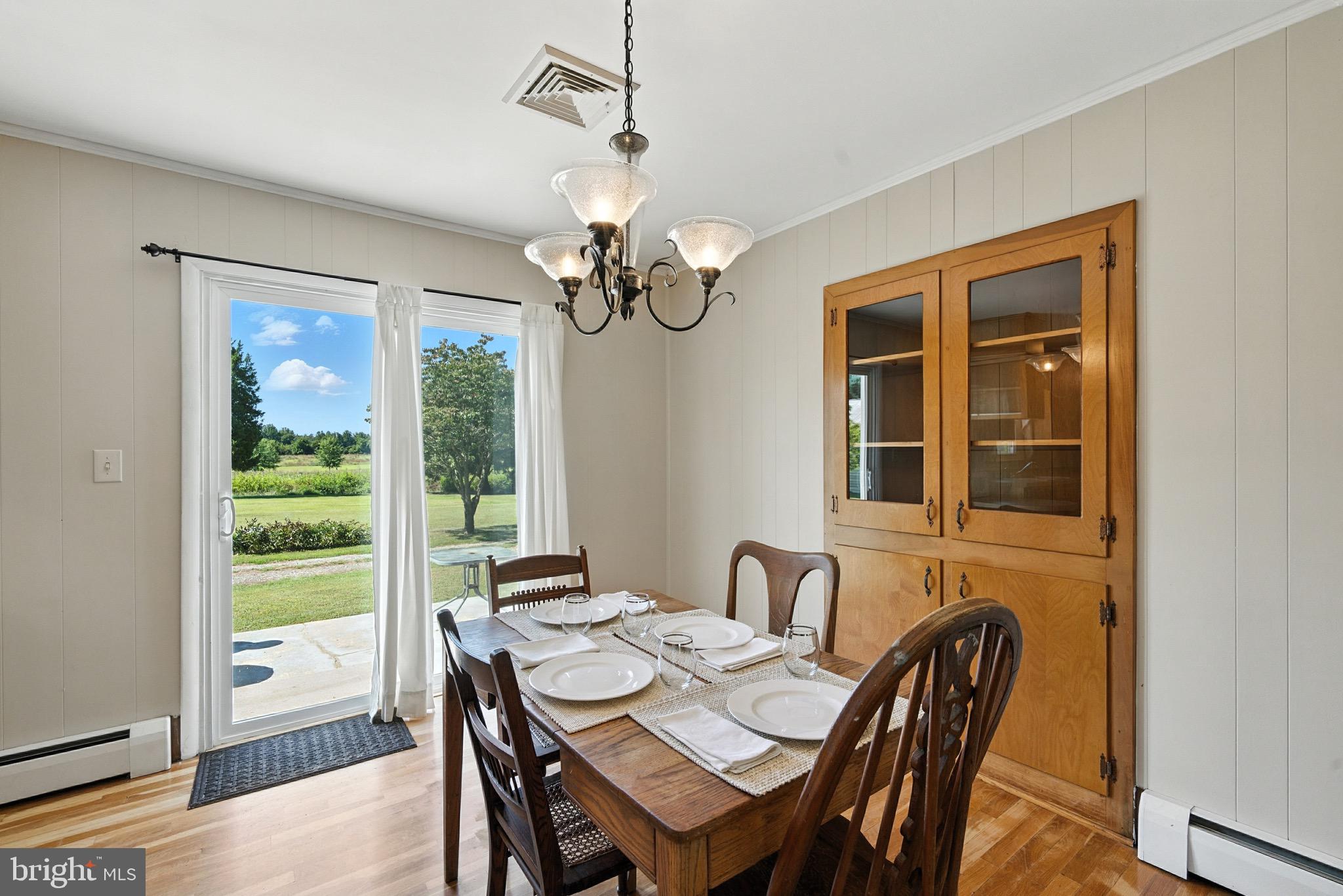 24415 Chestertown Road Chestertown, MD 21620 - Photo 6 of 29 a view of a dining room with furniture wooden floor and chandelier
