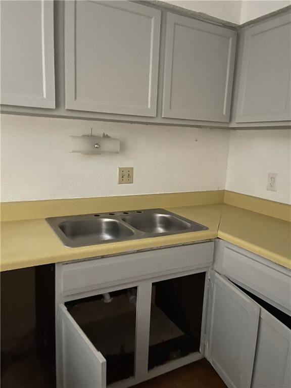 a view of a kitchen with sink and cabinets