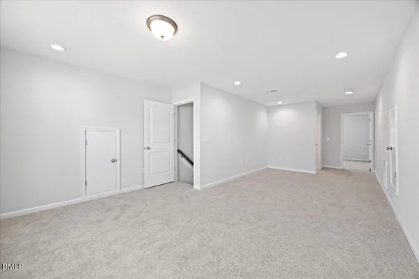 a view of an empty room with an entryway