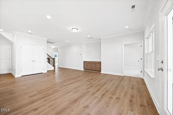 a kitchen with stainless steel appliances kitchen island wooden cabinets a center island and a window
