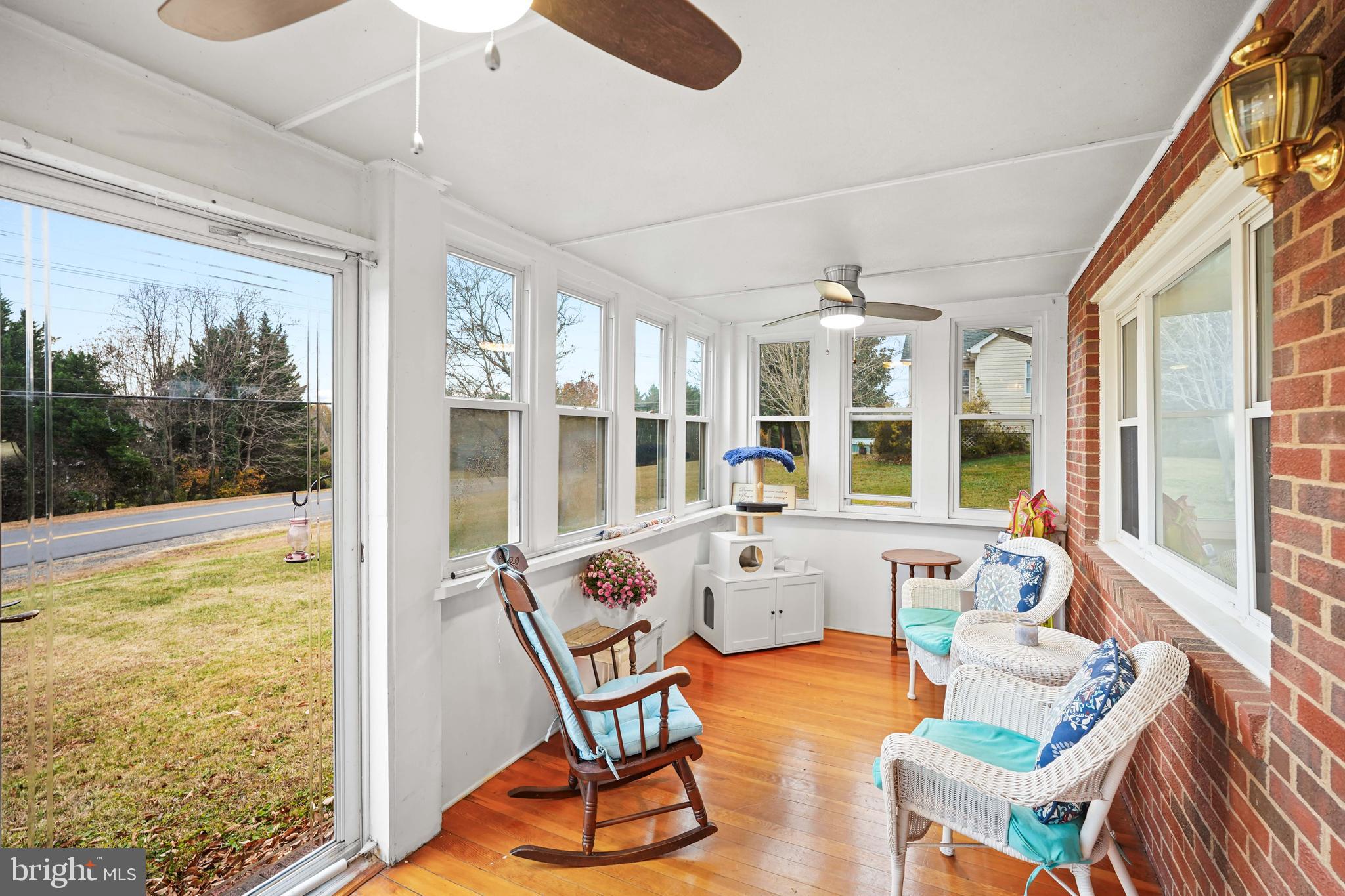 10012 Ellis Road Manassas, VA 20111 - Photo 14 of 54 a view of a dining room with furniture large windows and wooden floor