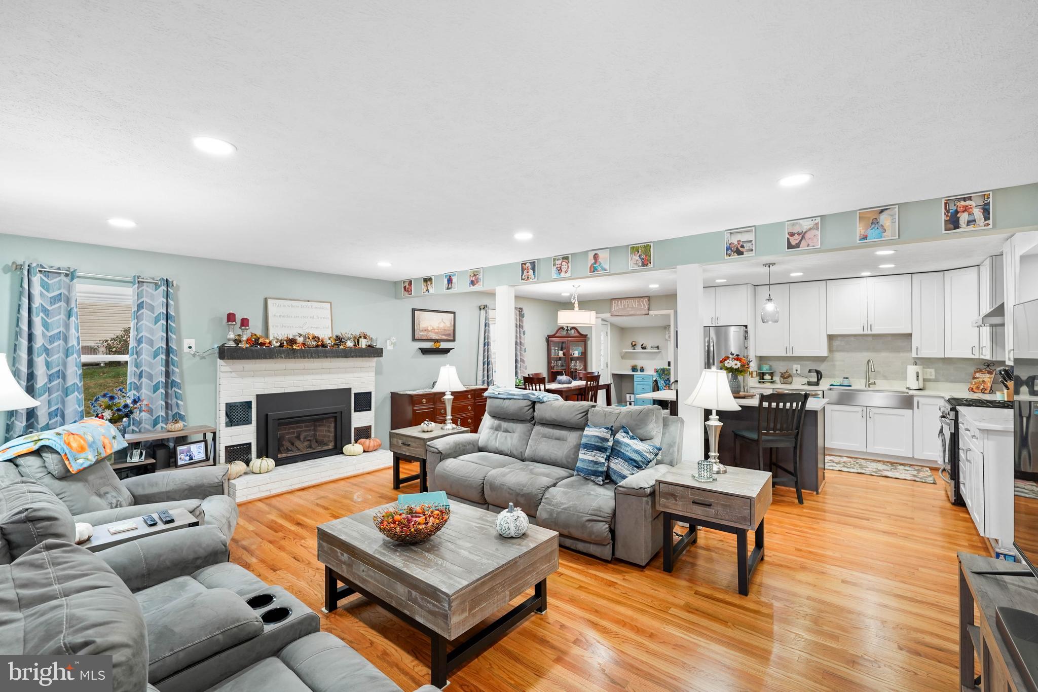 10012 Ellis Road Manassas, VA 20111 - Photo 16 of 54 a living room with furniture a table and kitchen view