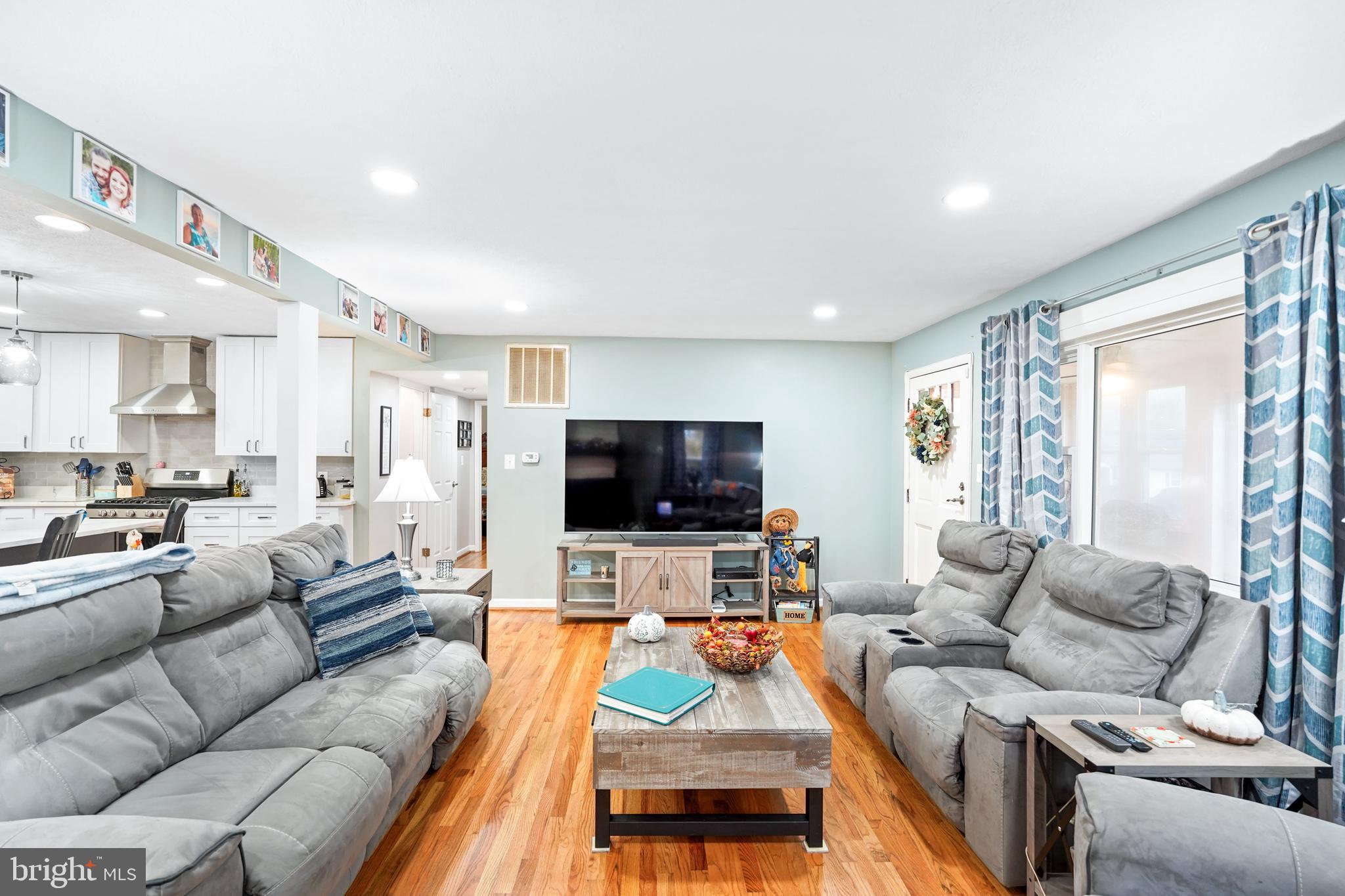 10012 Ellis Road Manassas, VA 20111 - Photo 17 of 54 a living room with furniture and a flat screen tv