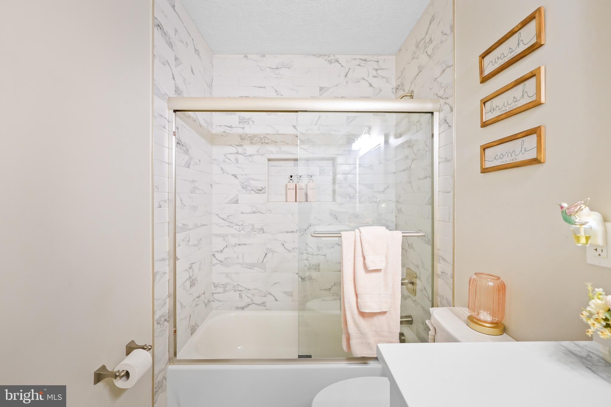 10012 Ellis Road Manassas, VA 20111 - Photo 29 of 54 a bathroom with a bathtub and shower