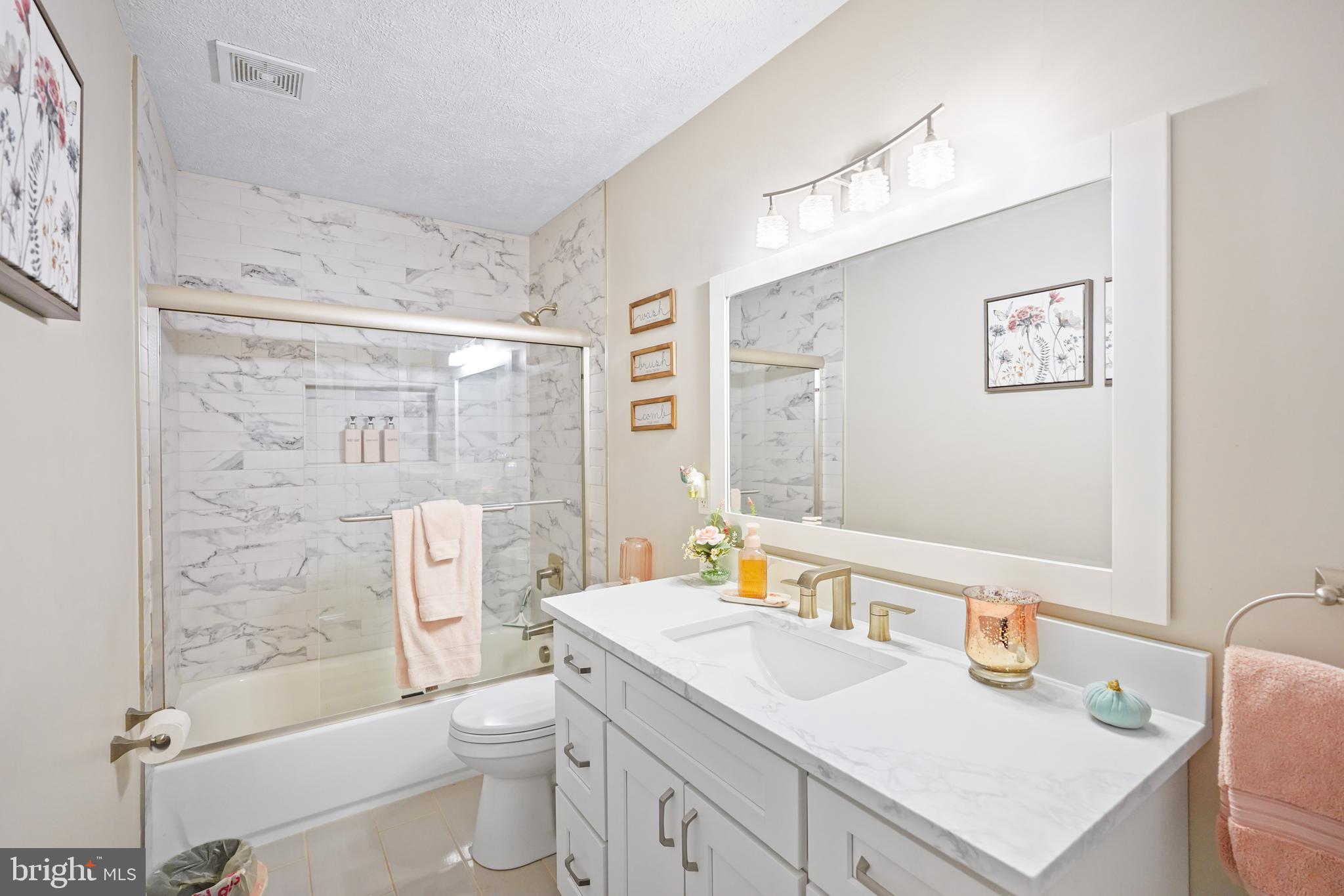 10012 Ellis Road Manassas, VA 20111 - Photo 31 of 54 a bathroom with a sink toilet vanity and shower