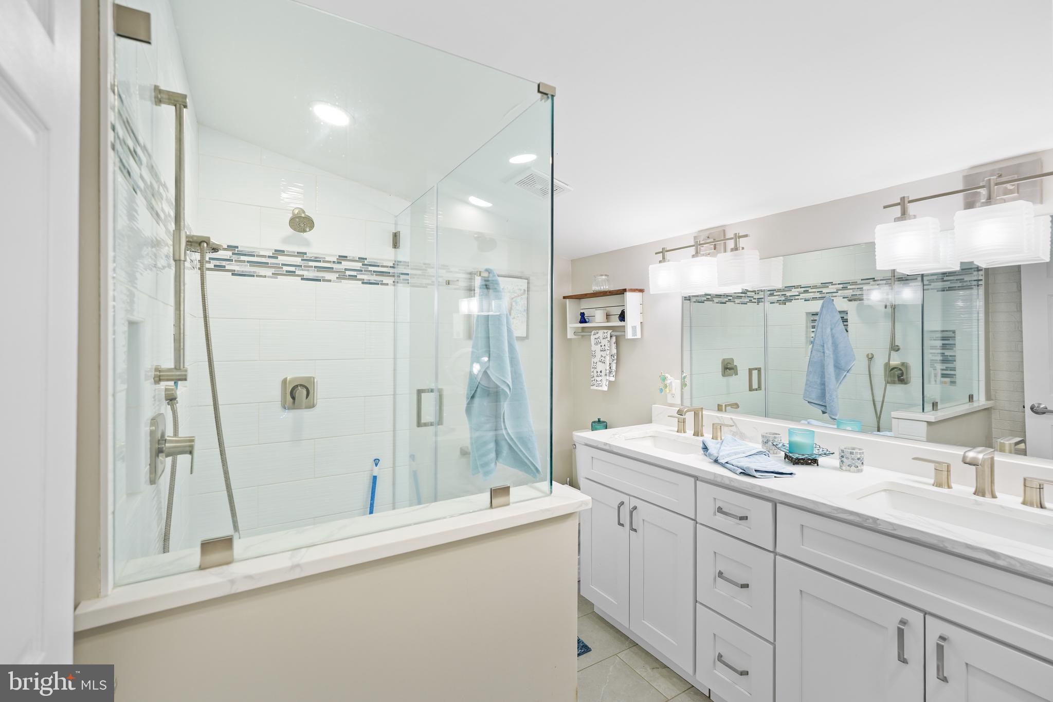 10012 Ellis Road Manassas, VA 20111 - Photo 34 of 54 a bathroom with a double vanity sink mirror double and shower