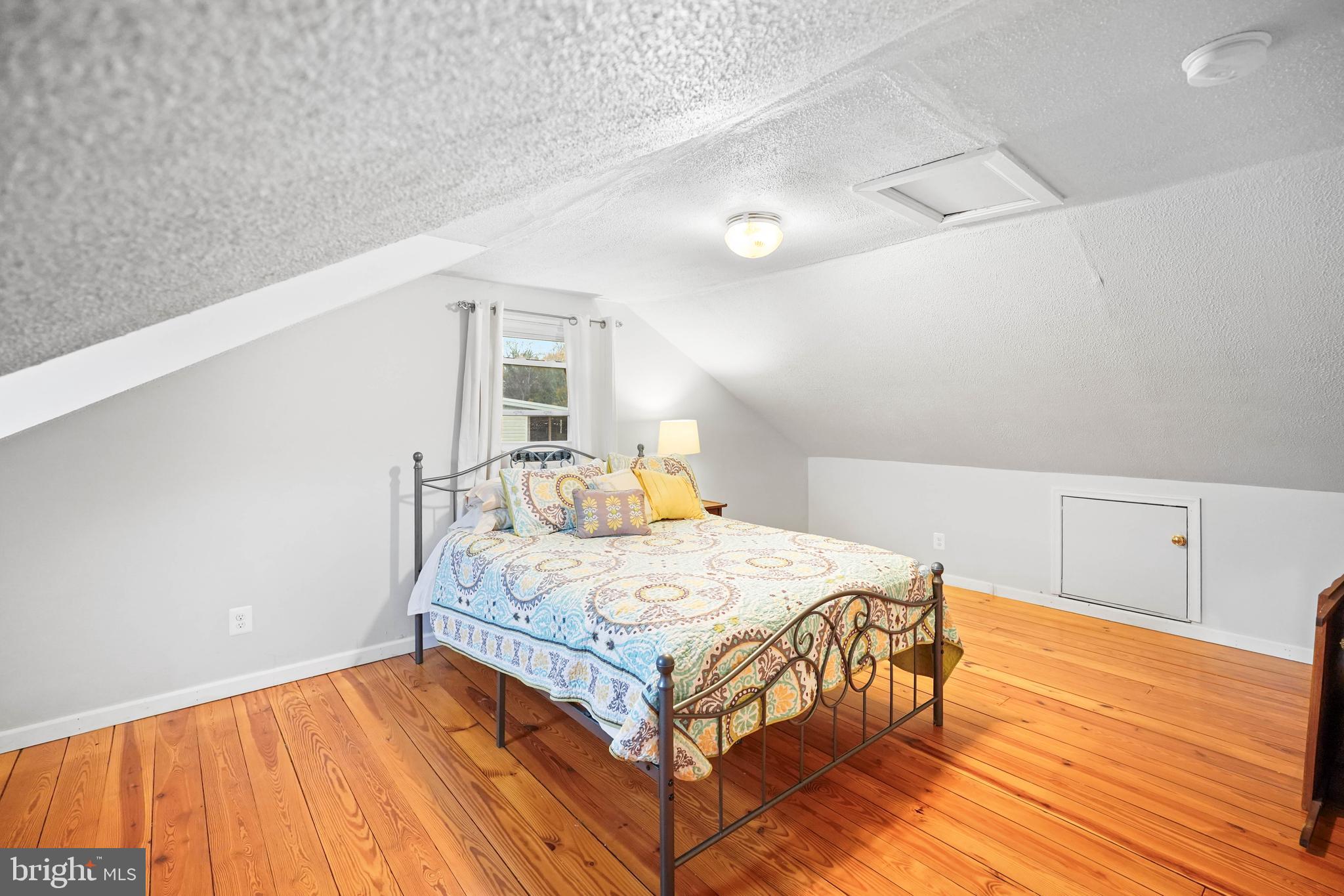 10012 Ellis Road Manassas, VA 20111 - Photo 47 of 54 a bedroom with a bed and wooden floor