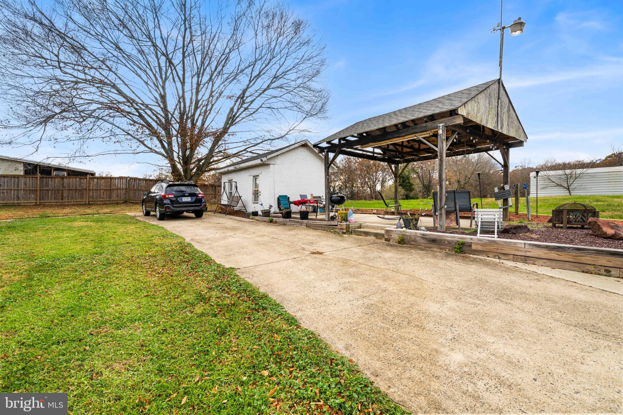 10012 Ellis Road Manassas, VA 20111 - Photo 7 of 54 a view of a swimming pool with a bench and trees