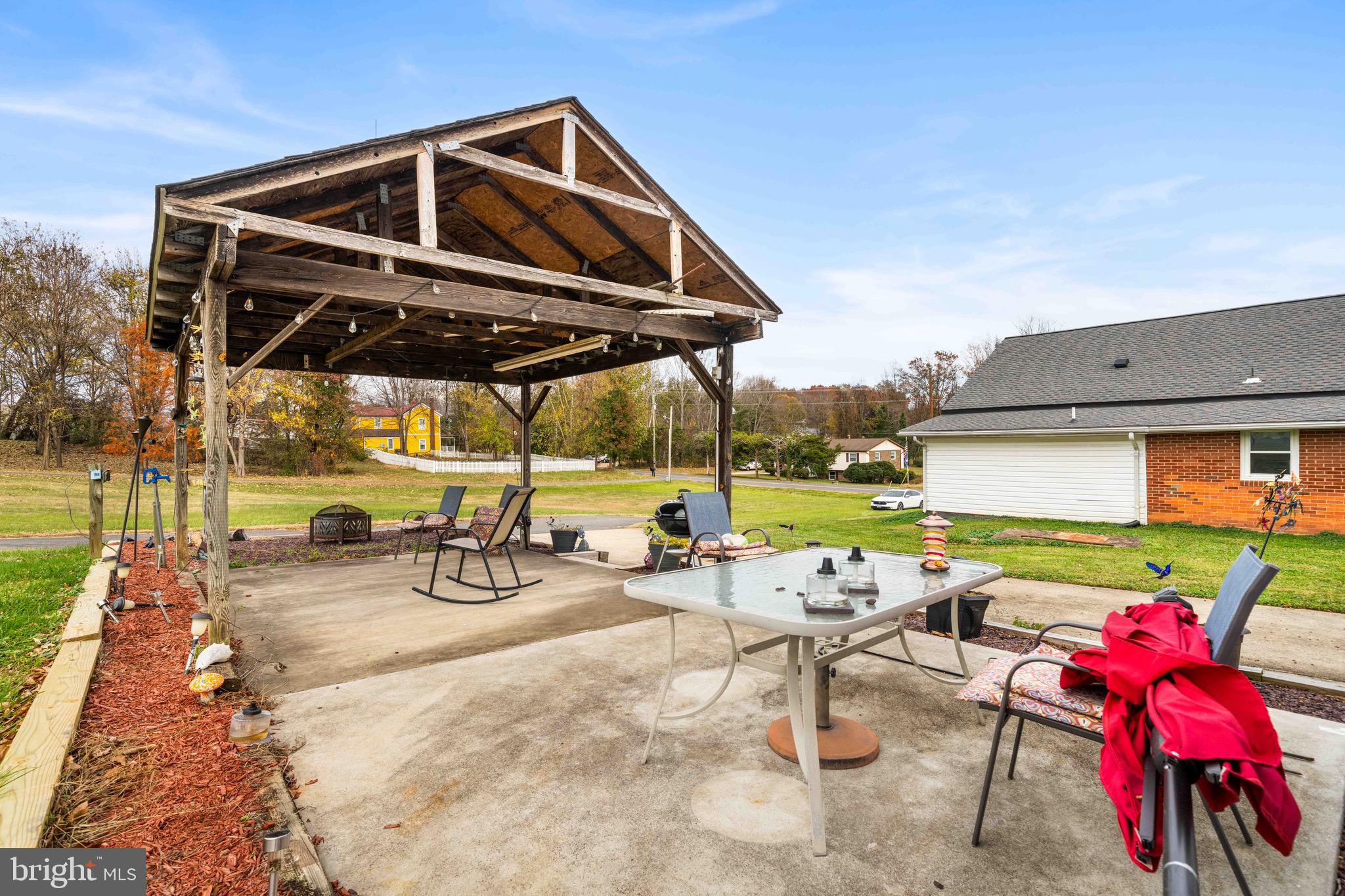 10012 Ellis Road Manassas, VA 20111 - Photo 8 of 54 a view of a patio with a table and chairs under an umbrella