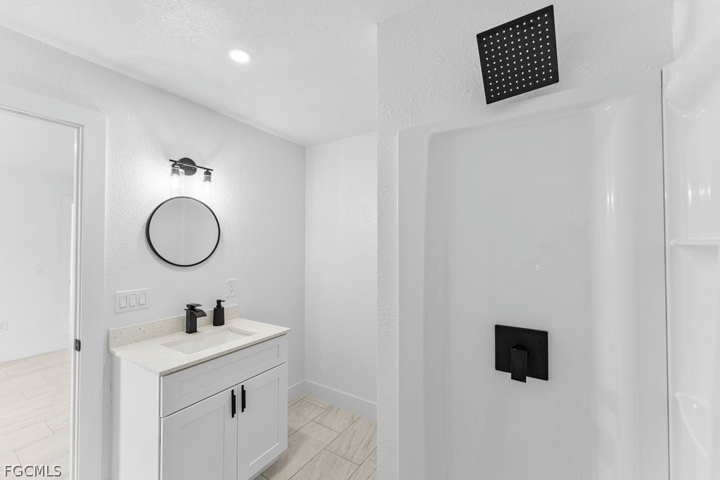 2512 42nd Street Southwest Lehigh Acres, FL 33976 - Photo 11 of 25 a bathroom with a sink and a mirror