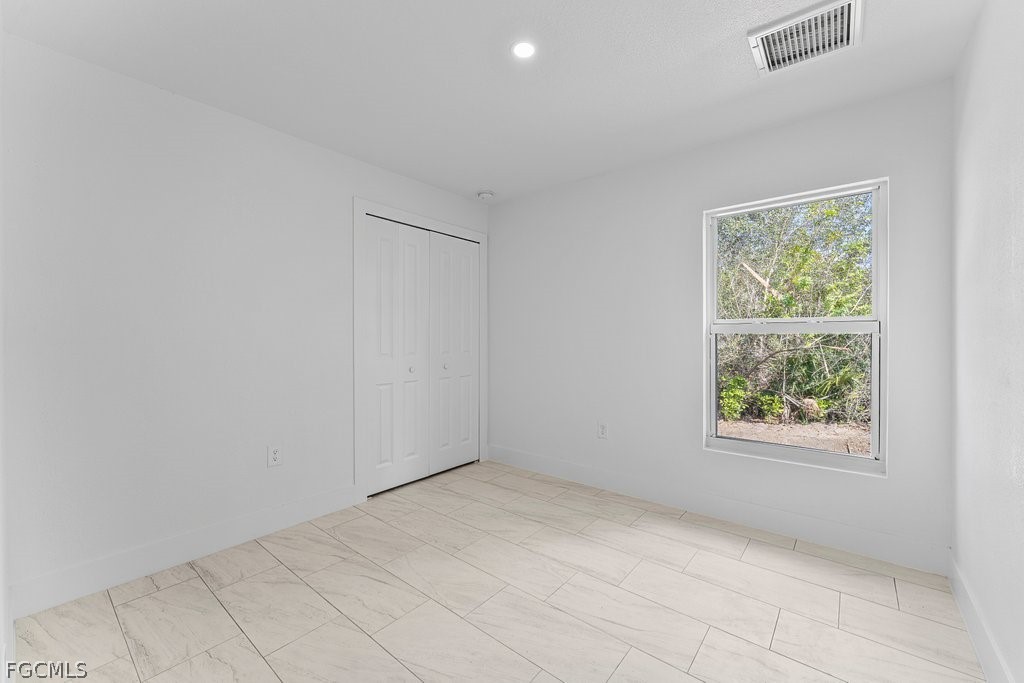 2512 42nd Street Southwest Lehigh Acres, FL 33976 - Photo 17 of 25 an empty room with windows
