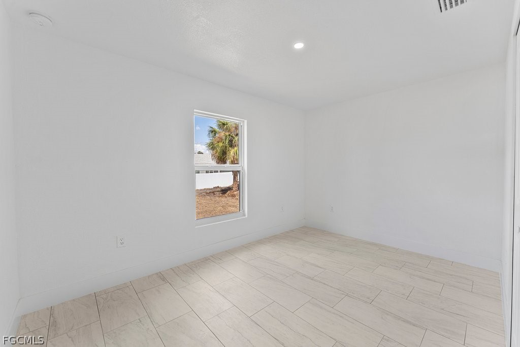 2512 42nd Street Southwest Lehigh Acres, FL 33976 - Photo 18 of 25 a view of an empty room with a window