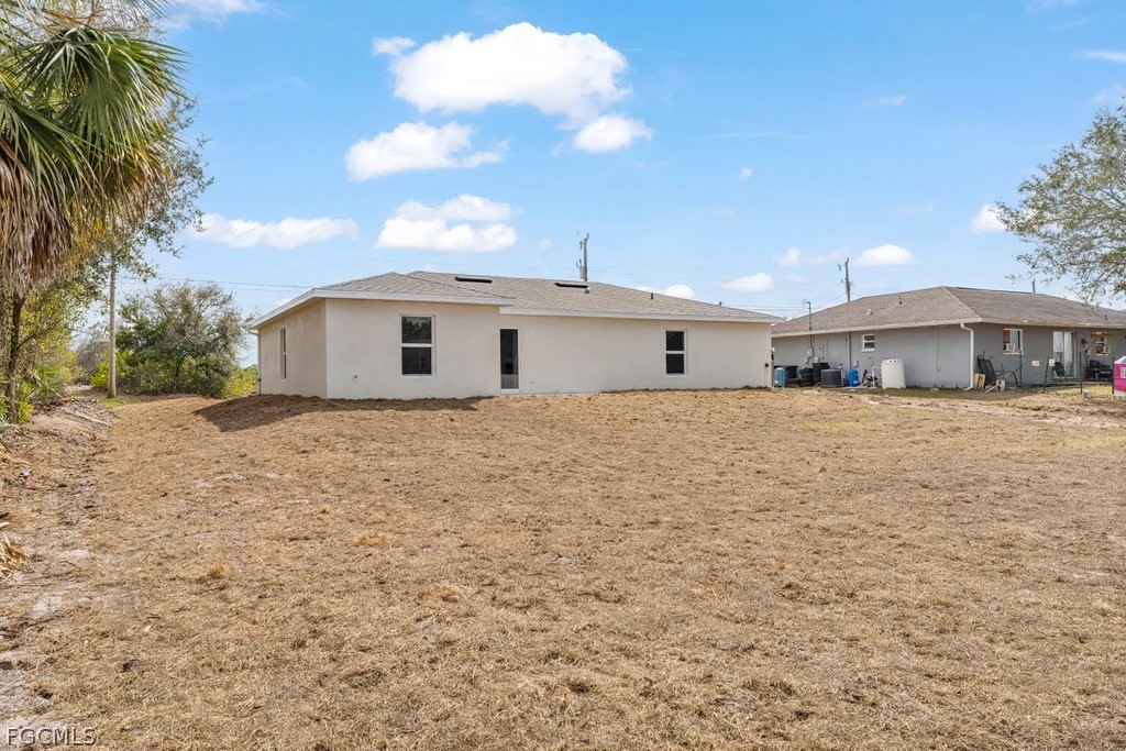 2512 42nd Street Southwest Lehigh Acres, FL 33976 - Photo 20 of 25 a front view of a house with a yard