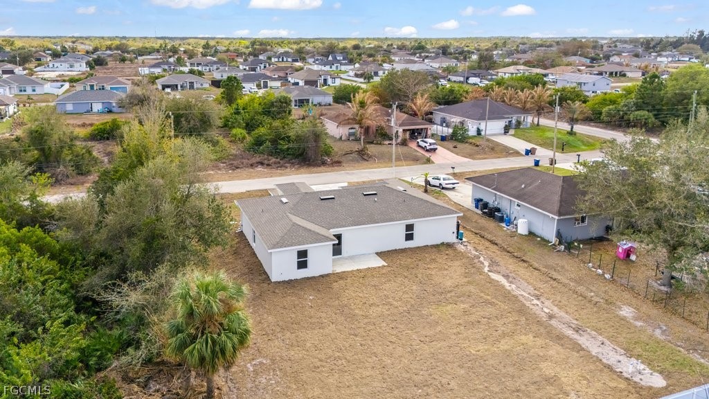 2512 42nd Street Southwest Lehigh Acres, FL 33976 - Photo 22 of 25 an aerial view of a house with a swimming pool and lake view