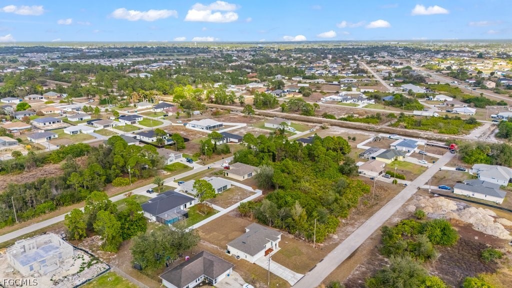 2512 42nd Street Southwest Lehigh Acres, FL 33976 - Photo 23 of 25 an aerial view of residential houses with outdoor space