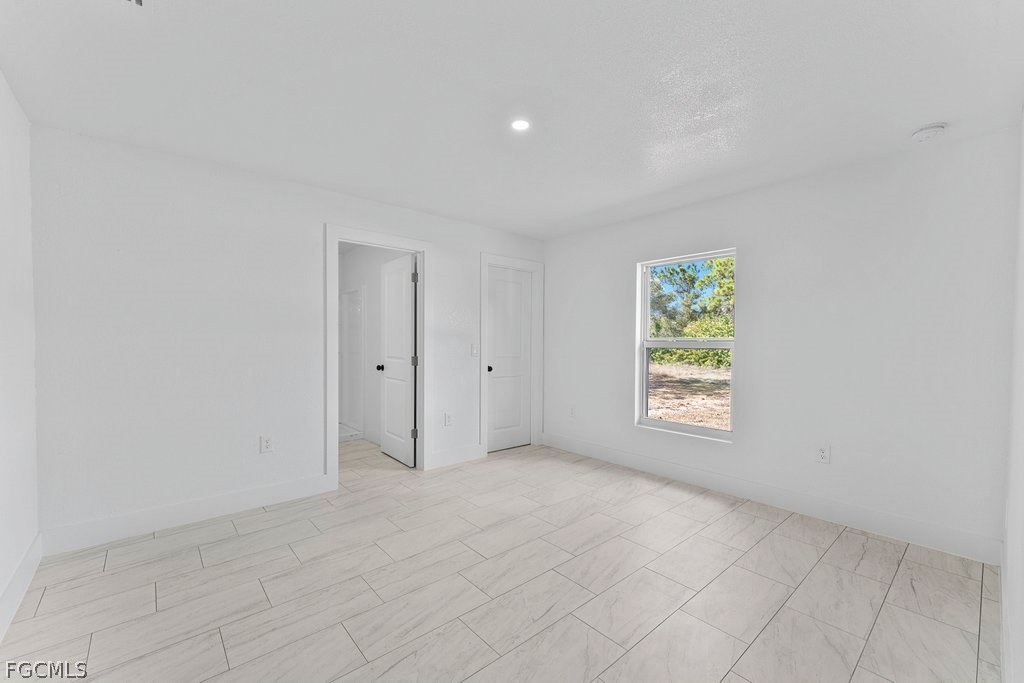 2512 42nd Street Southwest Lehigh Acres, FL 33976 - Photo 8 of 25 an empty room with windows