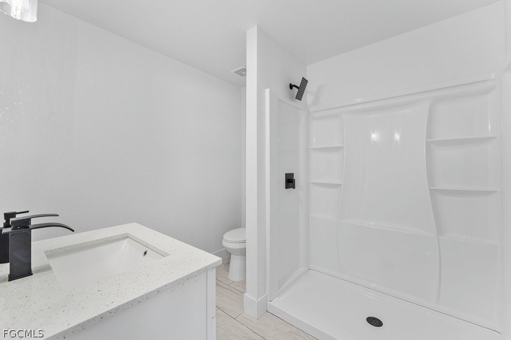 2512 42nd Street Southwest Lehigh Acres, FL 33976 - Photo 10 of 25 a bathroom with a shower and sink