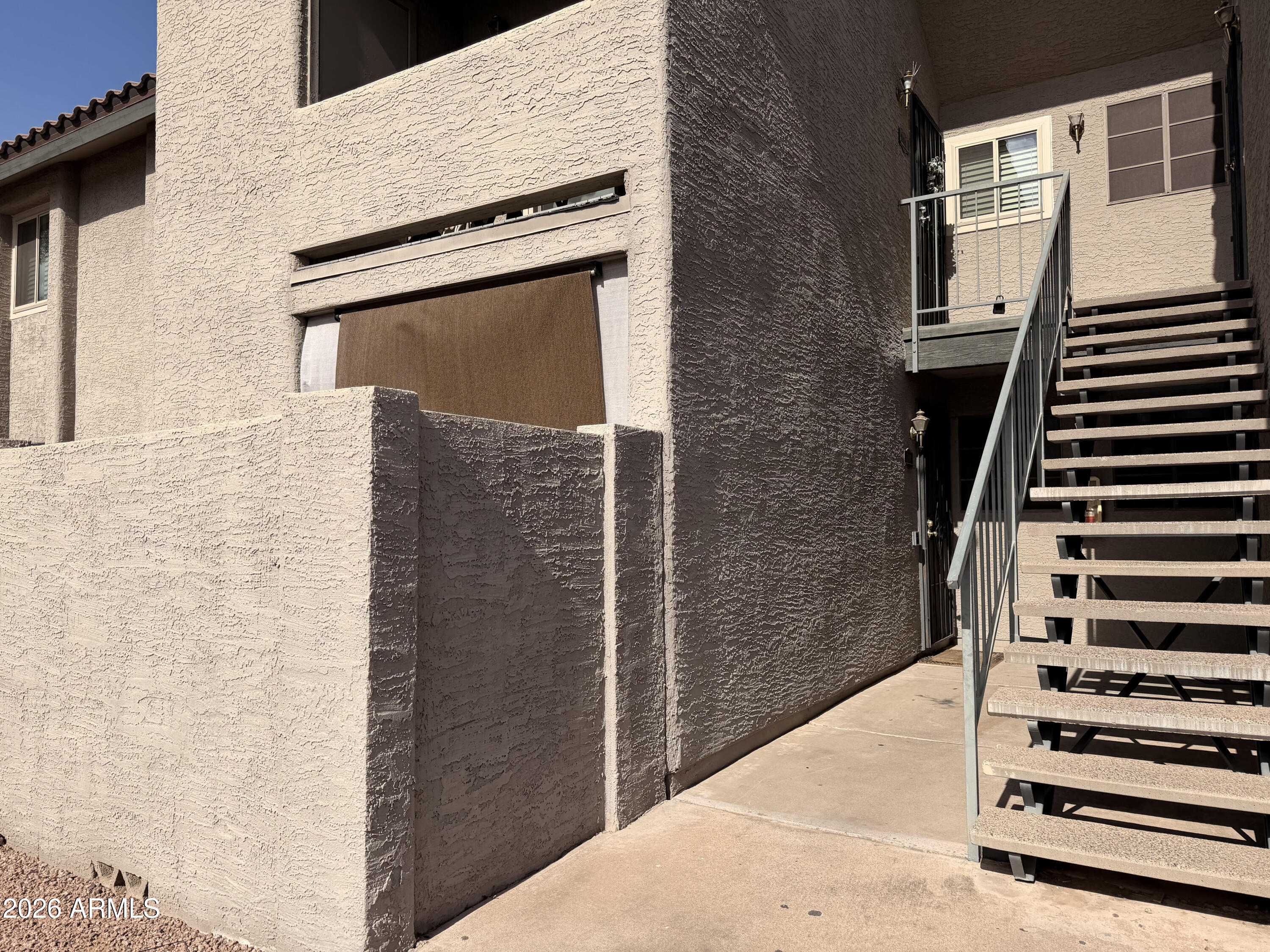 533 West Guadalupe Road, Unit 1104 Mesa, AZ 85210 - Photo 20 of 20 a view of a building with wooden door and stairs