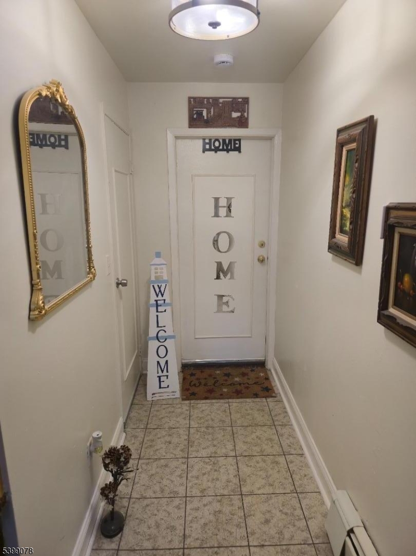 22 Sunset Avenue, Unit 2 Bayonne, NJ 07002 - Photo 1 of 11 a view of a hallway with paintings on the wall