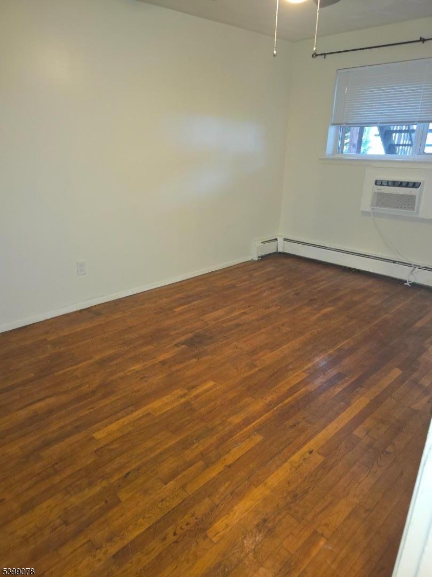 22 Sunset Avenue, Unit 2 Bayonne, NJ 07002 - Photo 4 of 11 a view of empty room with wooden floor
