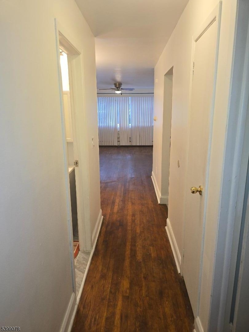 22 Sunset Avenue, Unit 2 Bayonne, NJ 07002 - Photo 6 of 11 a view of a hallway with wooden floor and staircase