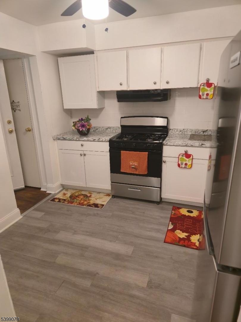 22 Sunset Avenue, Unit 2 Bayonne, NJ 07002 - Photo 10 of 11 a utility room with stainless steel appliances wooden floor and view living room