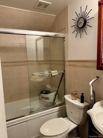 a bathroom with a toilet a sink and a shower
