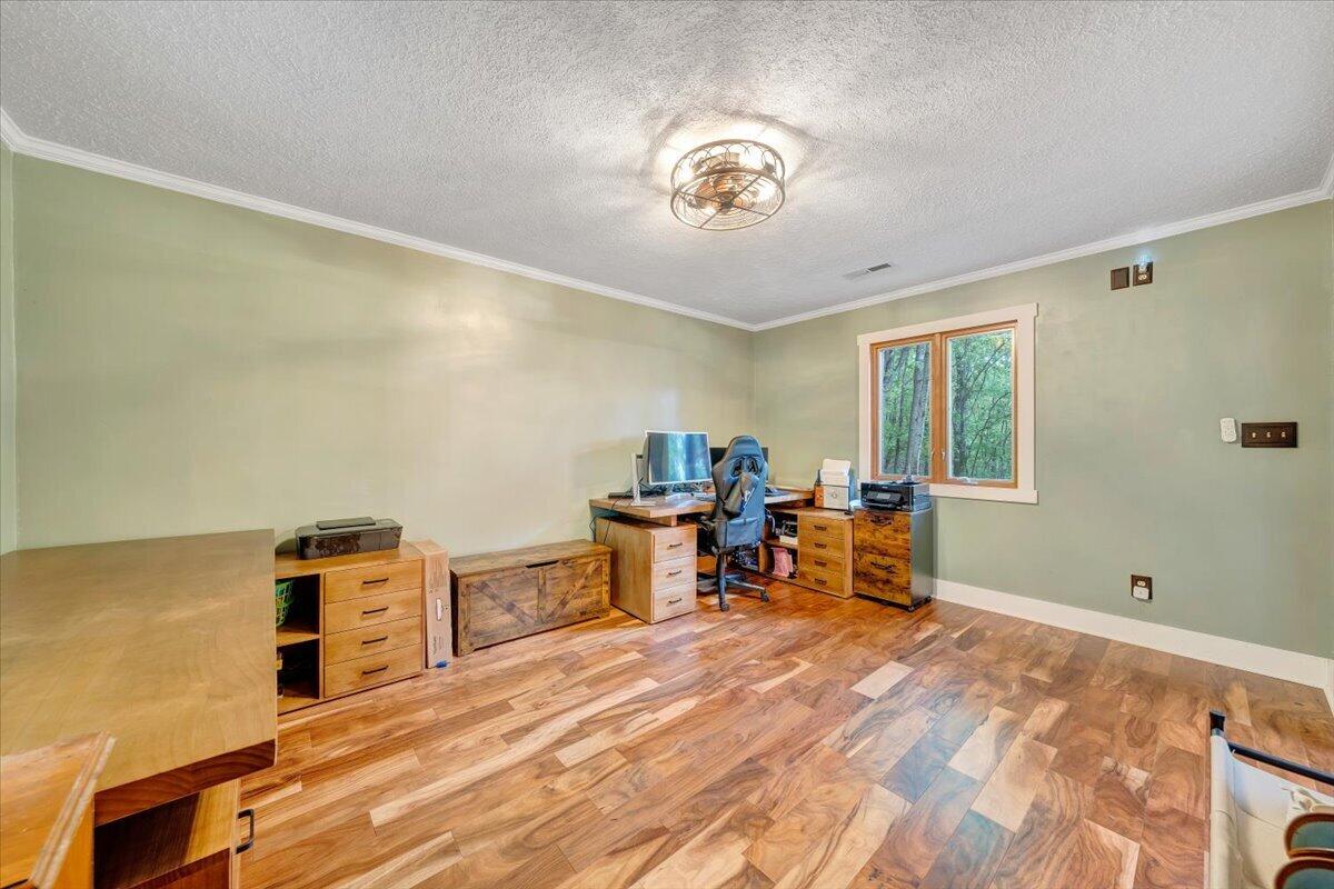 290 Silver Shadow Road Hardy, VA 24101 - Photo 29 of 62 a bedroom with a bed and a chandelier