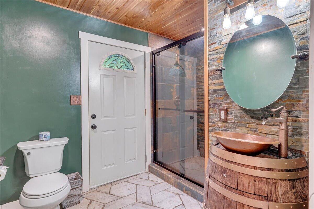 290 Silver Shadow Road Hardy, VA 24101 - Photo 31 of 62 a bathroom with a toilet a sink and glass door