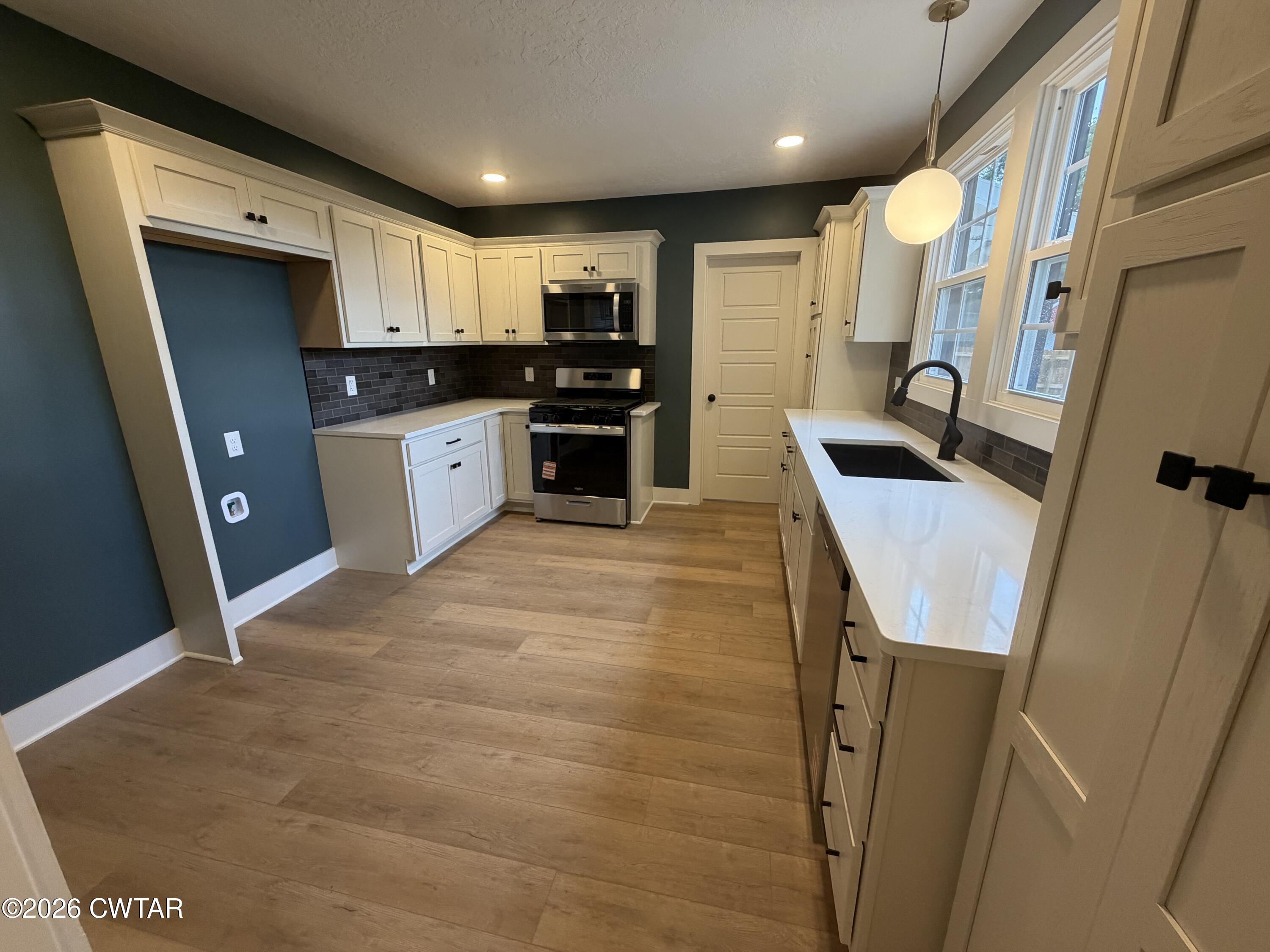 16 Manner Frank Road Milan, TN 38358 - Photo 10 of 25 a kitchen with stainless steel appliances granite countertop refrigerator sink and stove