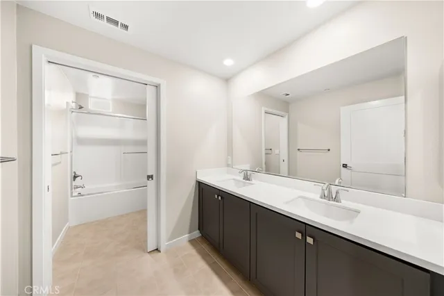 a white toilet sitting next to a bath tub