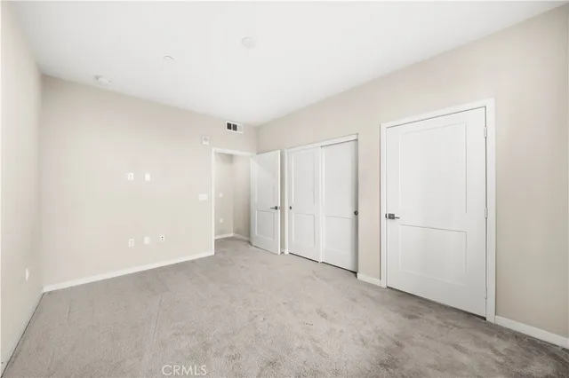 a view of an empty room with windows