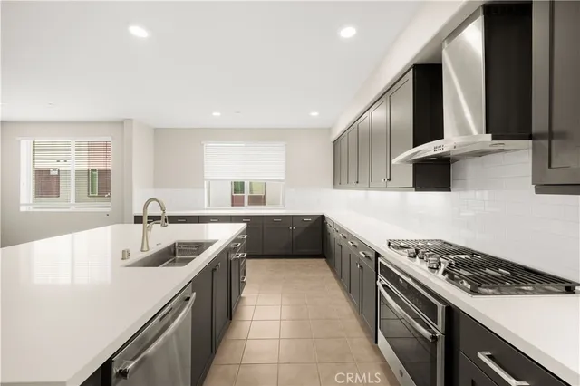 a kitchen with a sink and a stove top oven