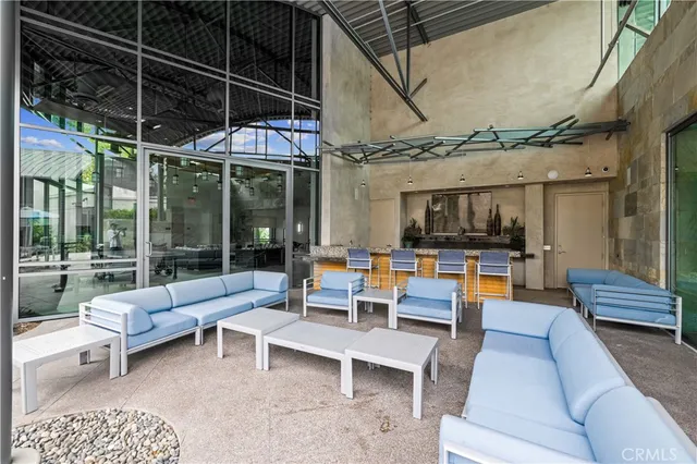 a view of a patio with table and chairs and potted plants