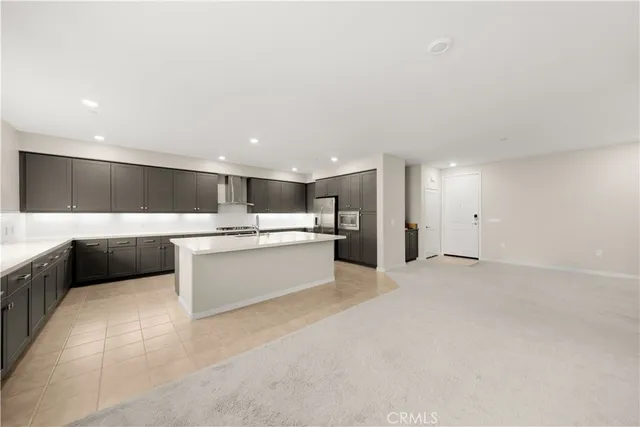 a large white kitchen with a white countertops and cabinets