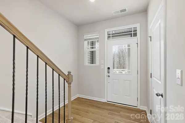 a view of an entryway with wooden floor