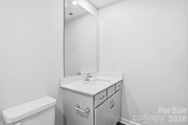 a bathroom with a sink toilet and mirror