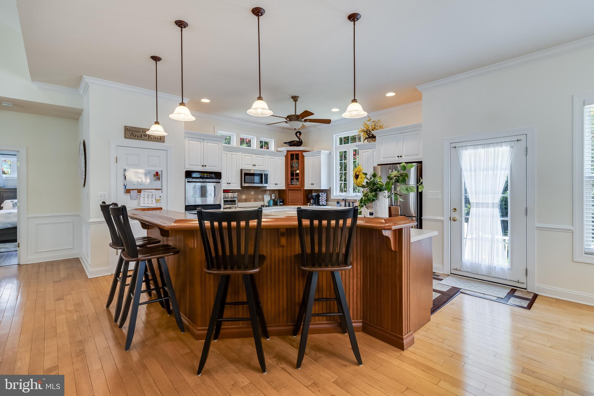 11375 Ethan Court Swan Point, MD 20645 - Photo 16 of 55 a view of a dining room and livingroom with furniture wooden floor a chandelier