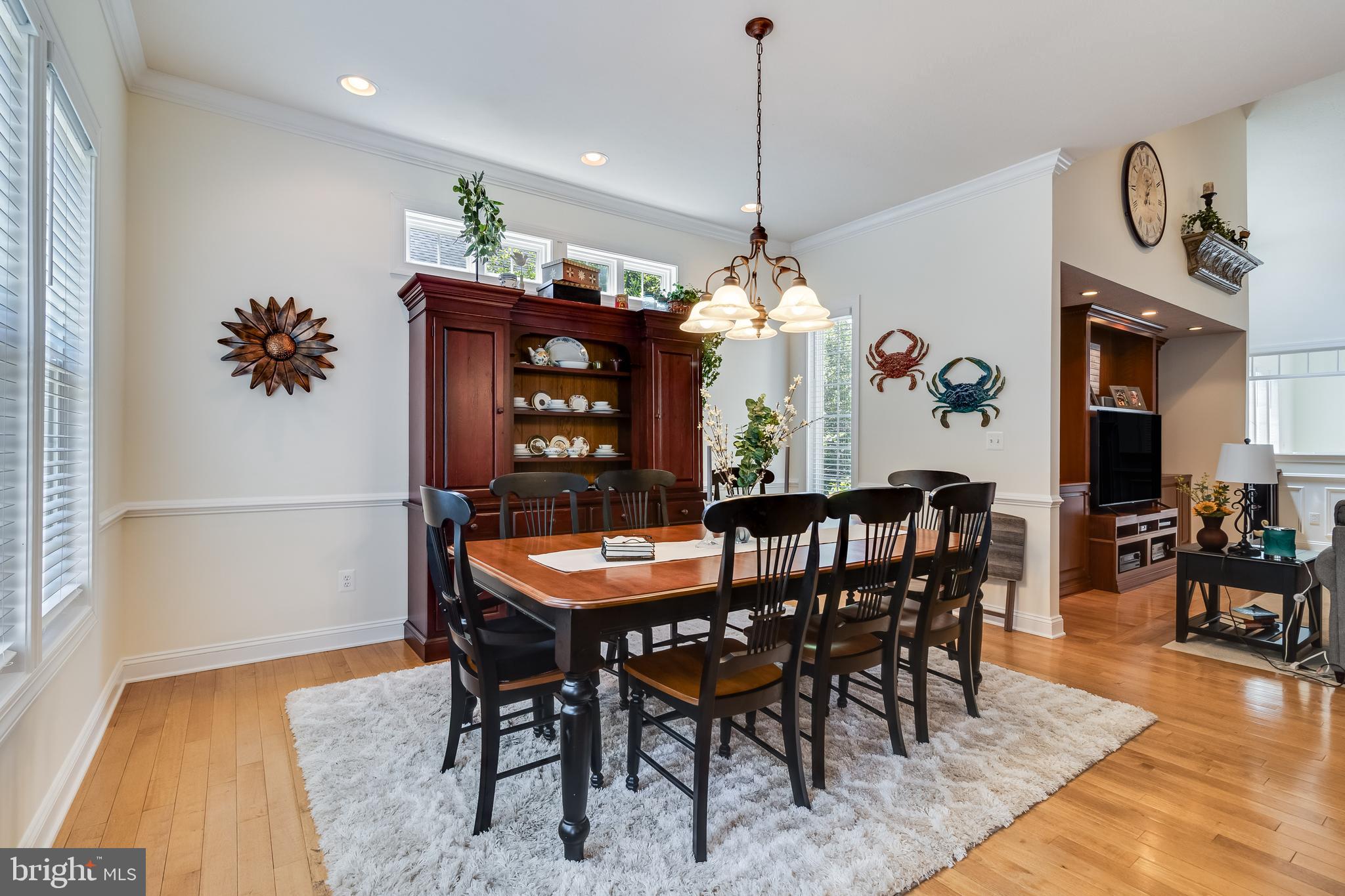11375 Ethan Court Swan Point, MD 20645 - Photo 20 of 55 a view of a dining room and livingroom furniture wooden floor a rug a potted plant and a chandelier