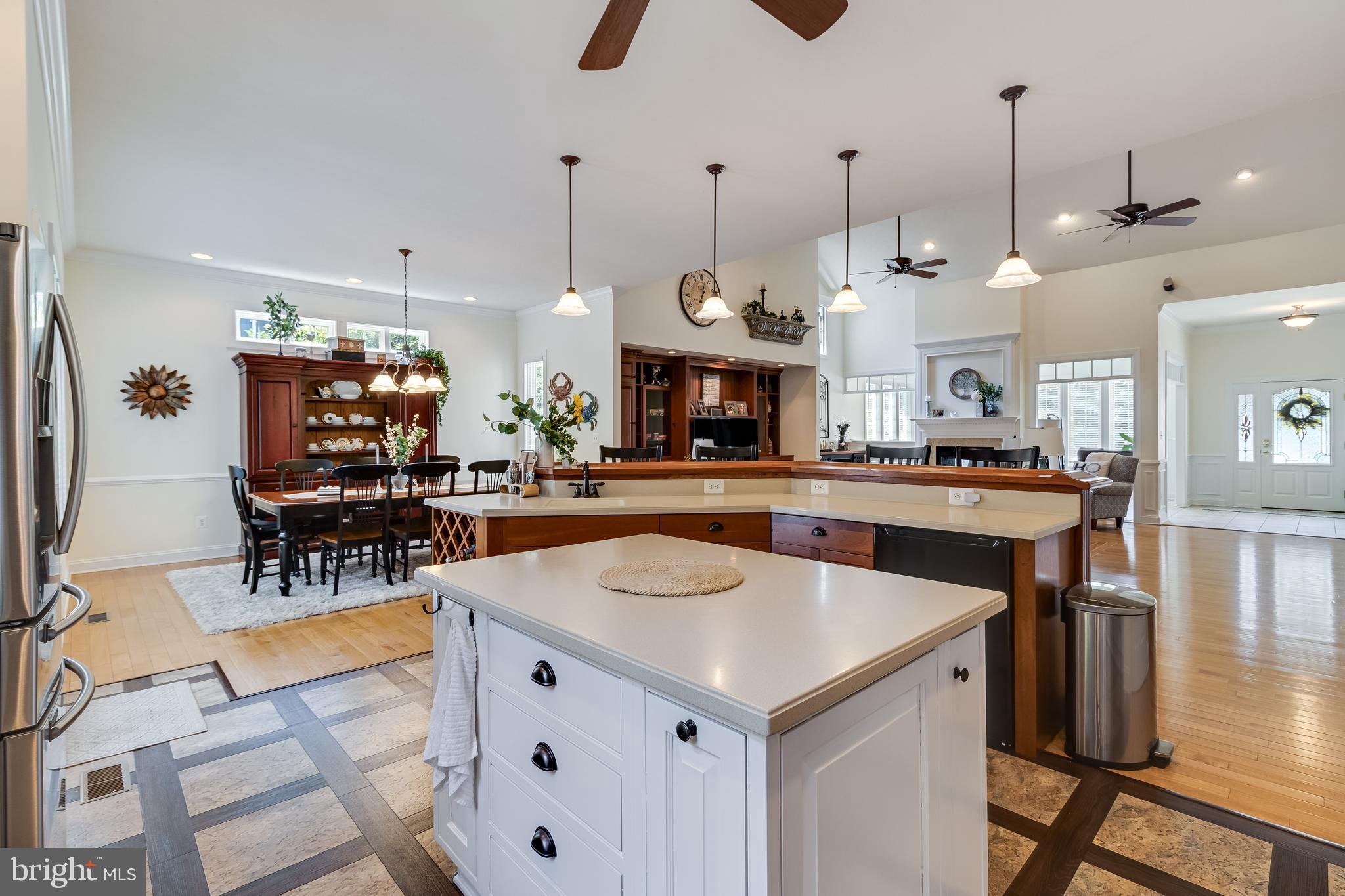 11375 Ethan Court Swan Point, MD 20645 - Photo 23 of 55 a kitchen with stainless steel appliances kitchen island granite countertop a table and chairs in it