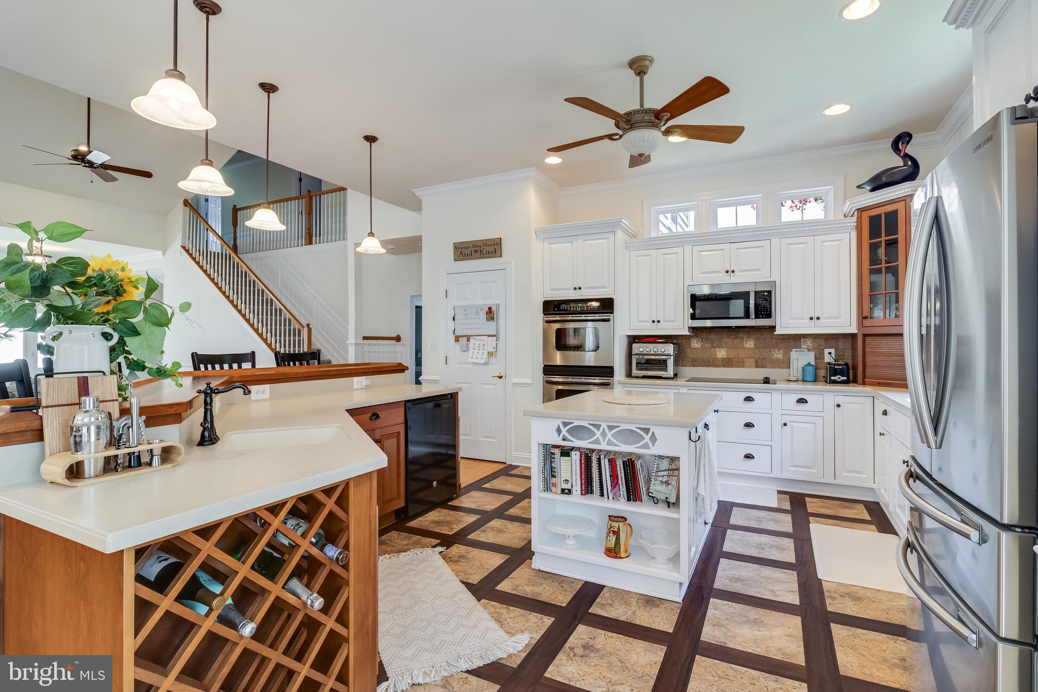 11375 Ethan Court Swan Point, MD 20645 - Photo 24 of 55 a kitchen with stainless steel appliances kitchen island granite countertop a refrigerator a stove a sink dishwasher a dining table and chairs with wooden floor