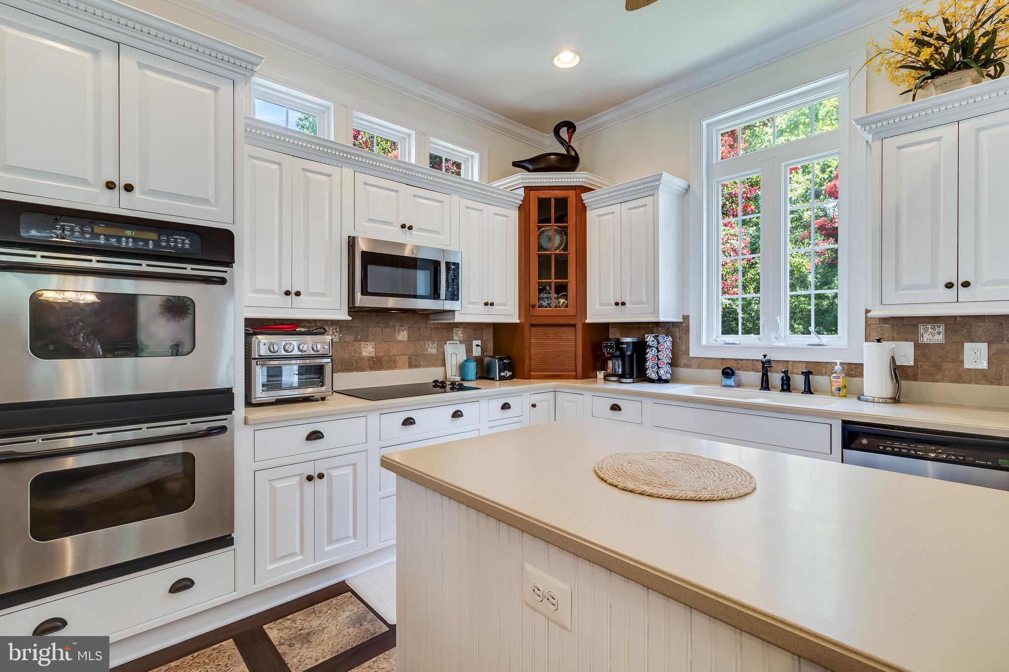 11375 Ethan Court Swan Point, MD 20645 - Photo 25 of 55 a kitchen with granite countertop a sink a stove a microwave and wooden cabinets