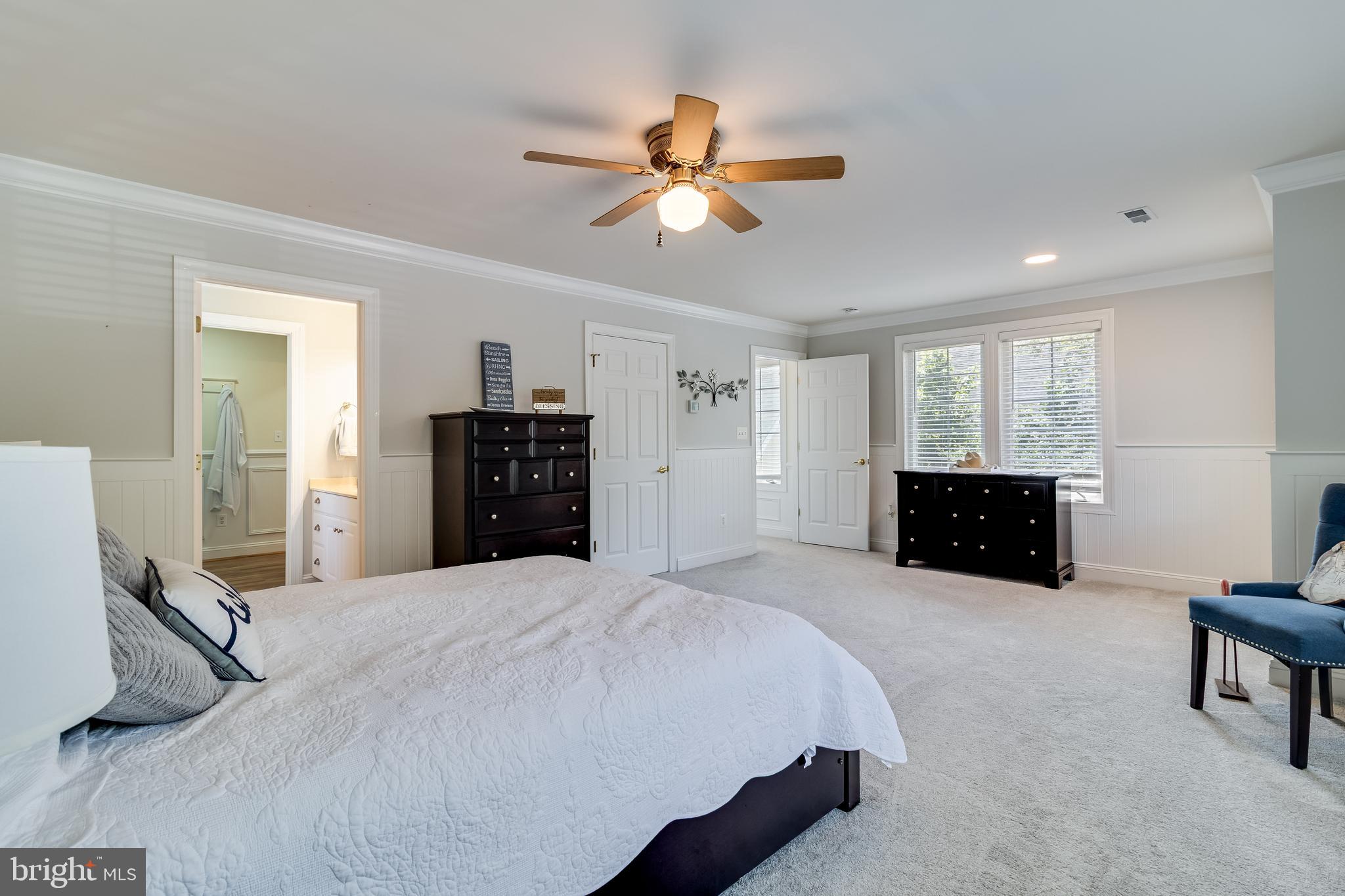 11375 Ethan Court Swan Point, MD 20645 - Photo 38 of 55 a large bedroom with a bed and a chandelier