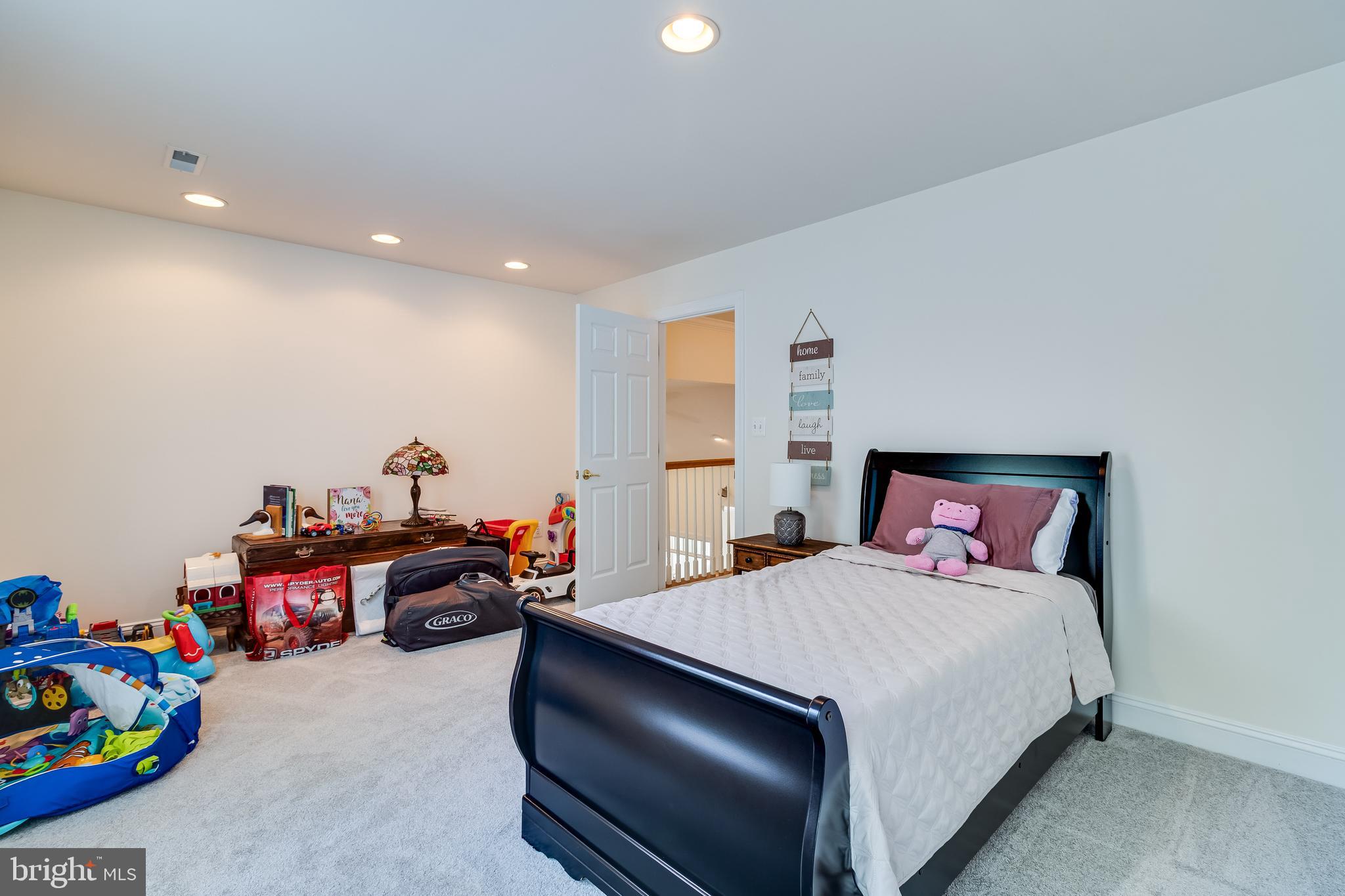 11375 Ethan Court Swan Point, MD 20645 - Photo 47 of 55 a bedroom with a bed and a chandelier