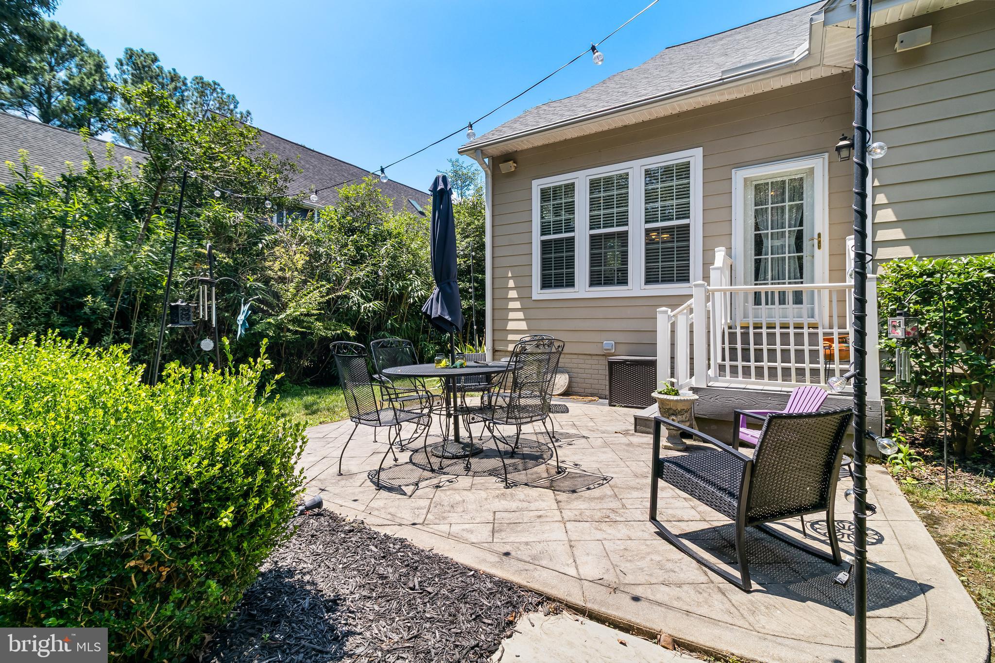 11375 Ethan Court Swan Point, MD 20645 - Photo 50 of 55 a view of a patio with table and chairs with wooden floor and plants