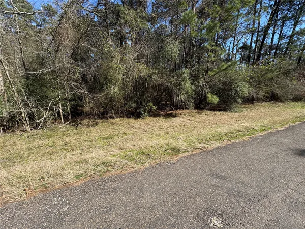 a view of empty space with wooden fence