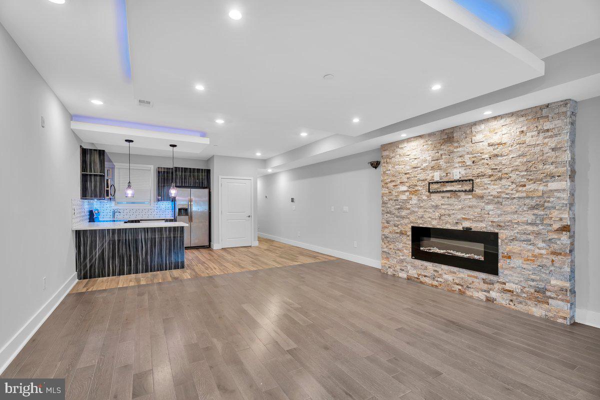 2562 Frankford Avenue, Unit 2 Philadelphia, PA 19125 - Photo 2 of 23 a open kitchen with a sink and a fireplace