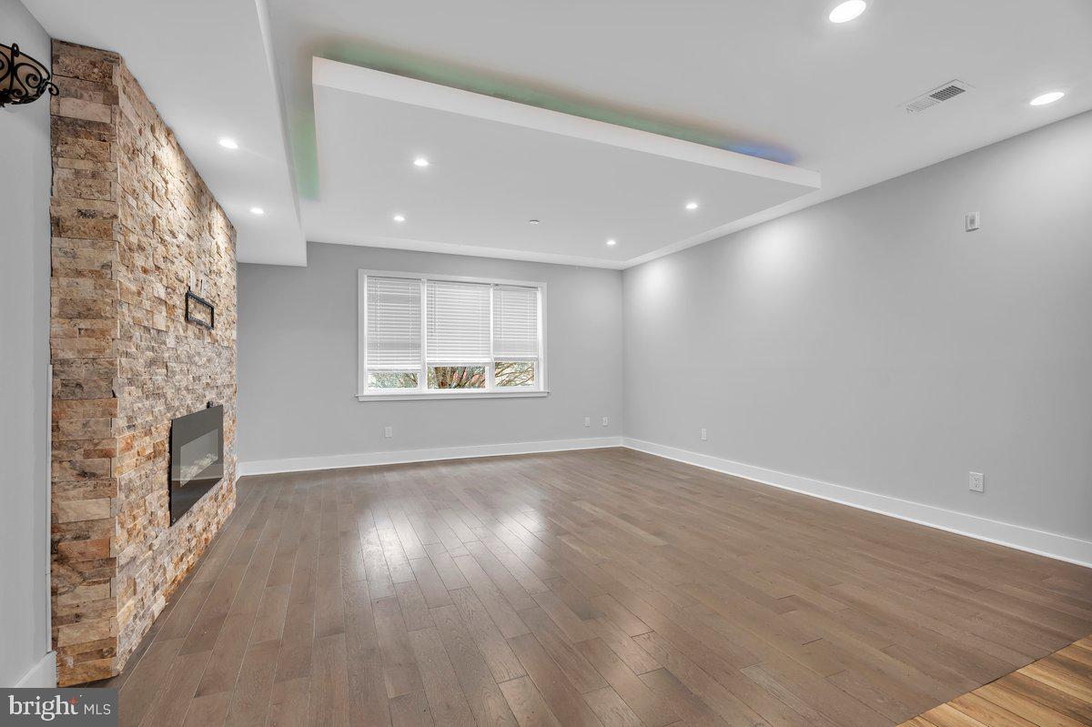 2562 Frankford Avenue, Unit 2 Philadelphia, PA 19125 - Photo 8 of 23 an empty room with wooden floor and windows