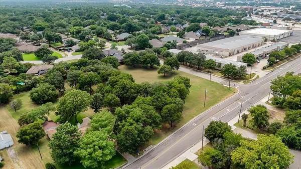 an aerial view of a house with a yard and lake view
